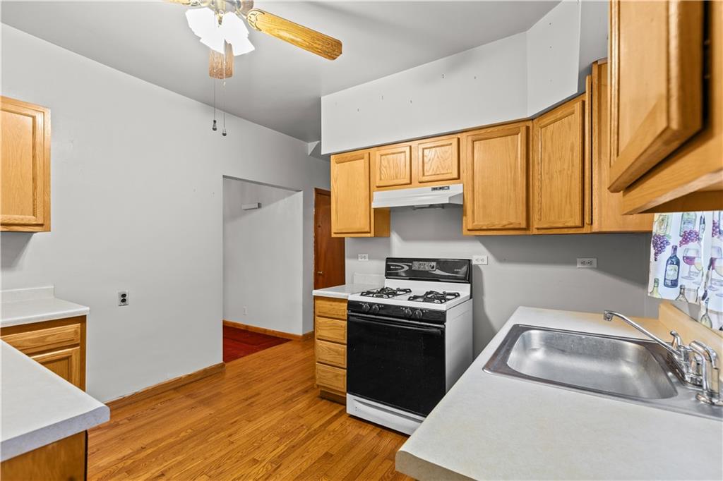 109 Helen Street McKees Rocks, PA 15136 - Photo 17 of 31 a kitchen with stainless steel appliances granite countertop a sink stove and refrigerator