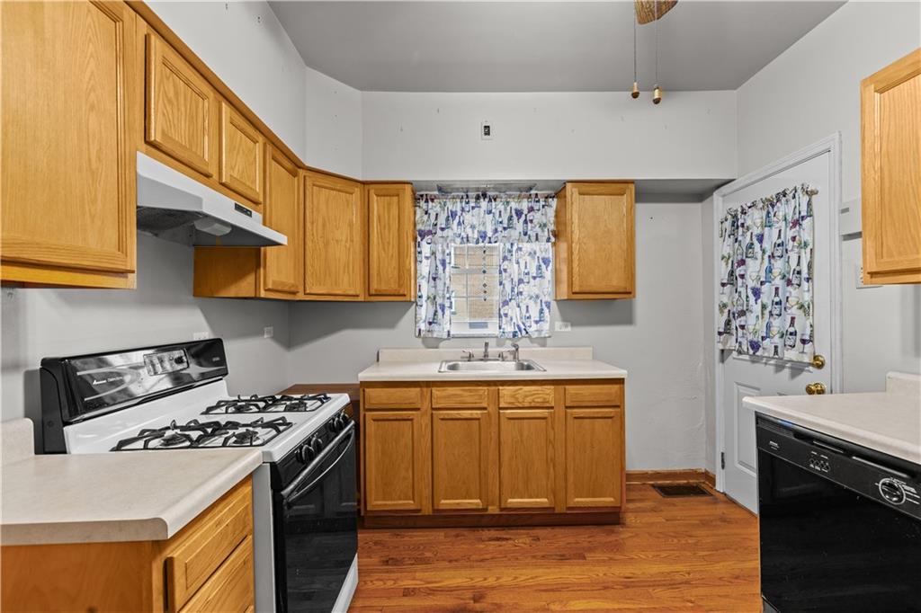 109 Helen Street McKees Rocks, PA 15136 - Photo 18 of 31 a kitchen with stainless steel appliances a stove a sink a refrigerator and cabinets