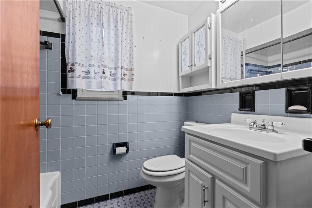 109 Helen Street McKees Rocks, PA 15136 - Photo 27 of 31 a bathroom with a sink a toilet and mirror