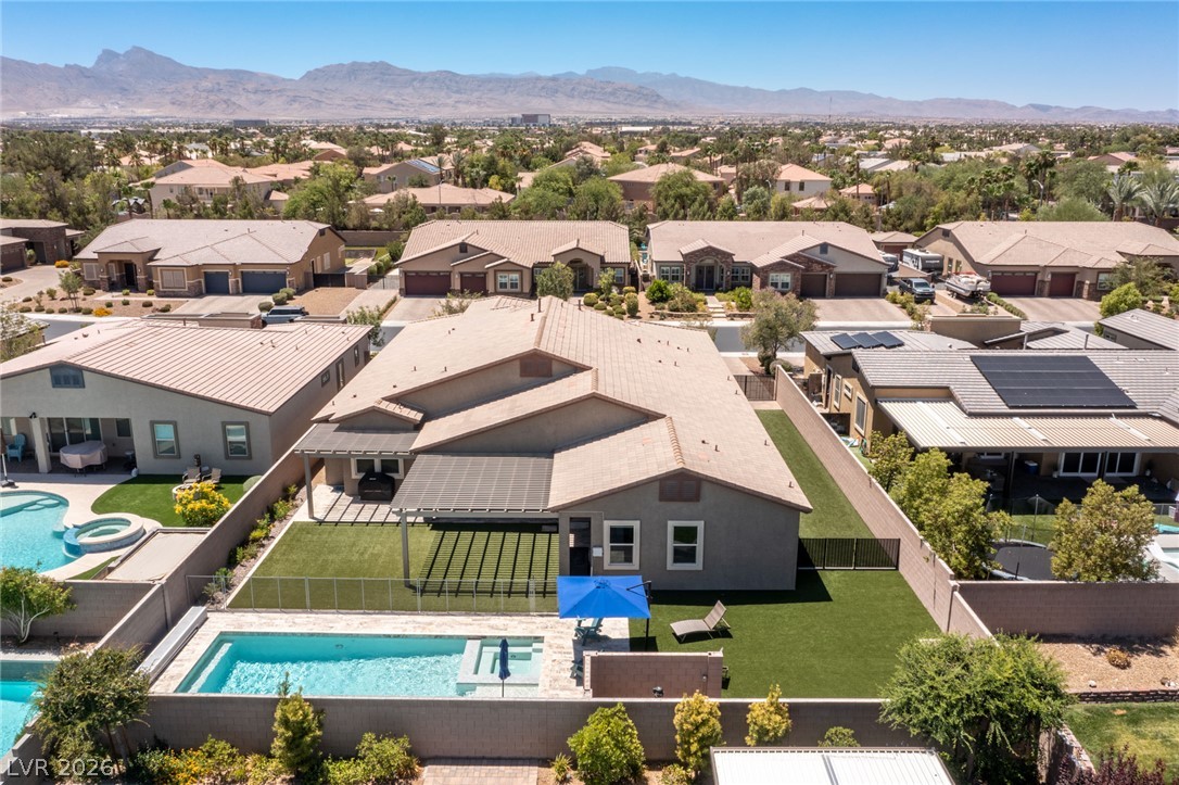 7036 Arabian Ridge Street Las Vegas, NV 89131 - Photo 4 of 64 Aerial view of this single story on its sprawling lot with plenty of covered patio and pergola space to help keep cool on those hot summer days and a sparkling pool and spa!