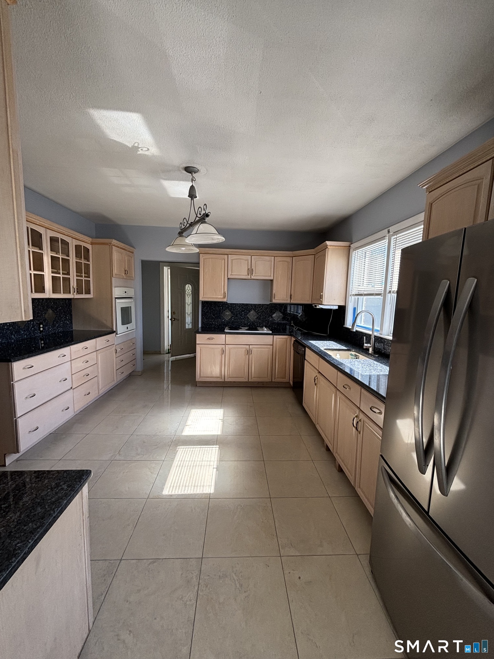 552 Franklin Avenue Hartford, CT 06114 - Photo 6 of 21 a large kitchen with cabinets and stainless steel appliances