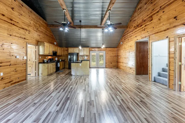 a view of a room with wooden floor