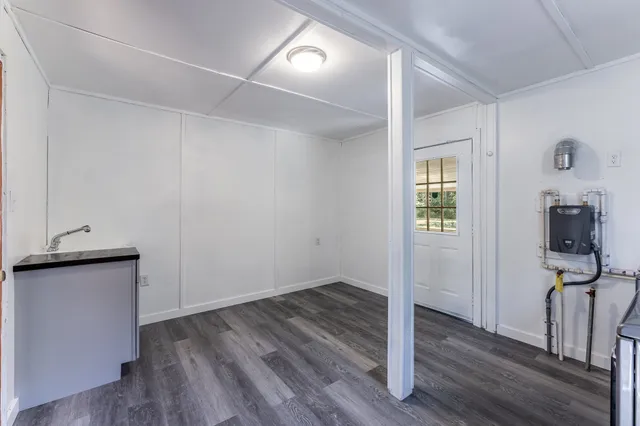 a kitchen with stainless steel appliances kitchen island wooden floors and white cabinets