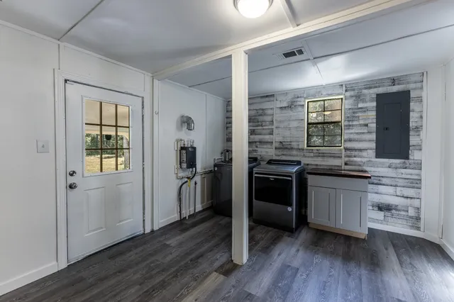 a kitchen with stainless steel appliances and wooden floor