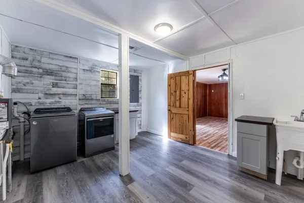 a view of empty room with wooden floor