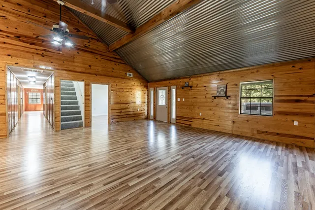 a view of a room with wooden floors