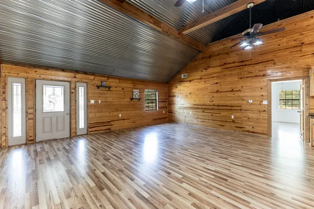 a view of empty room with wooden floor