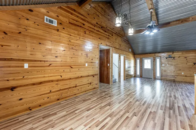 a view of a hall with wooden floor