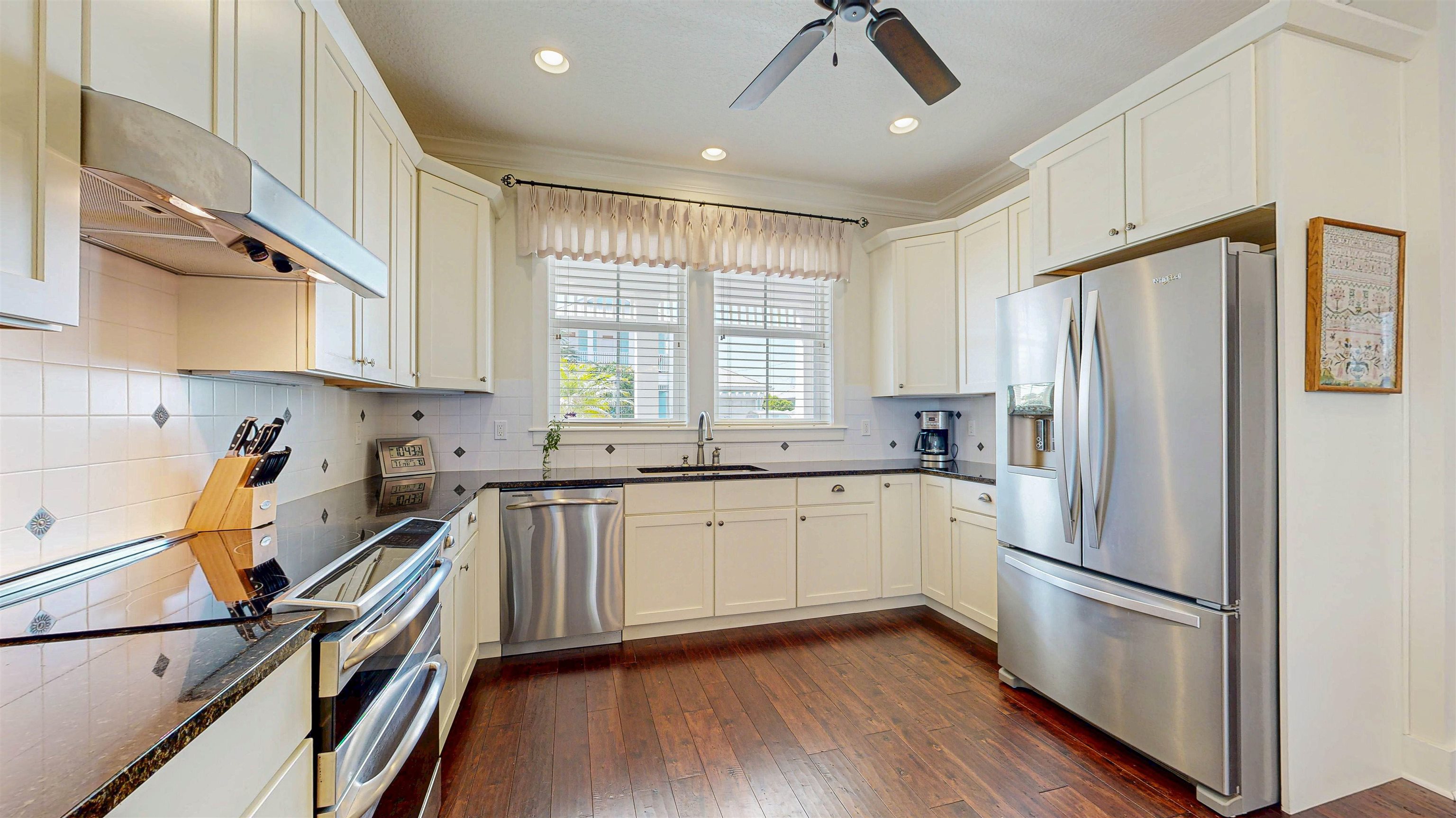 200 12th Street St. Augustine, FL 32080 - Photo 16 of 42 a kitchen with a refrigerator a sink and cabinets