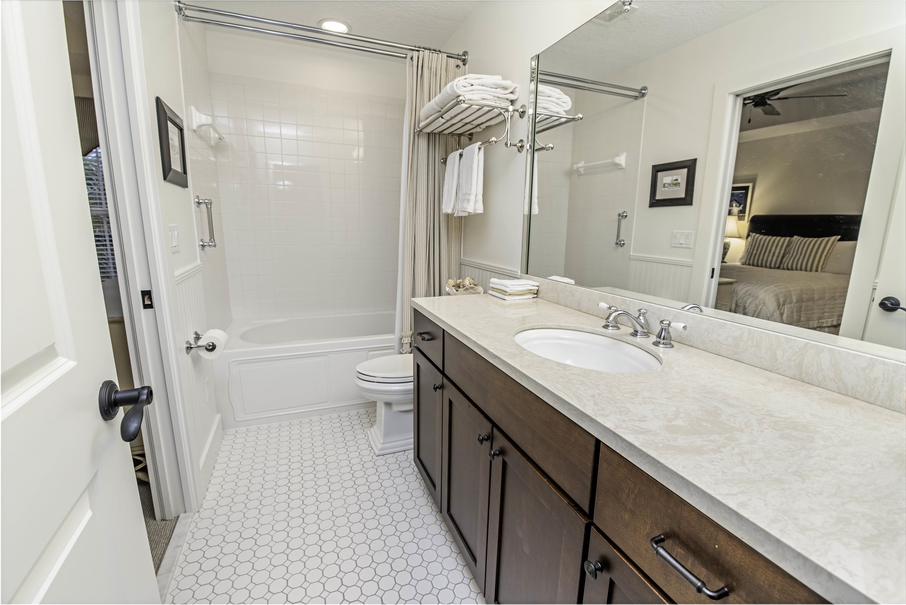 200 12th Street St. Augustine, FL 32080 - Photo 27 of 42 a bathroom with a double vanity sink toilet mirror and shower