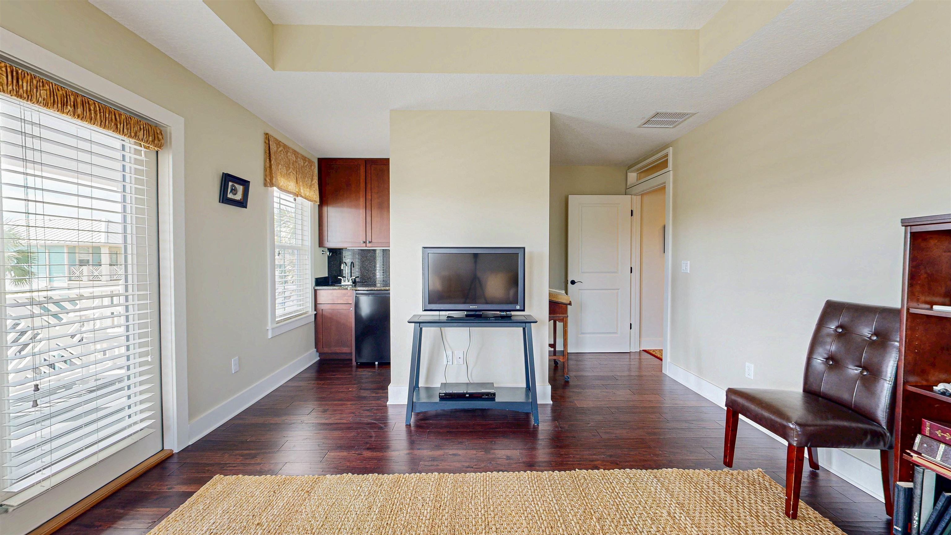 200 12th Street St. Augustine, FL 32080 - Photo 29 of 42 a living room with furniture and a flat screen tv