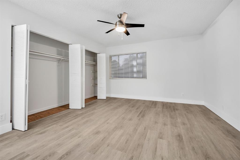7743 Balboa Street, Unit 7743 Sunrise, FL 33351 - Photo 12 of 21 an empty room with wooden floor chandelier fan and windows
