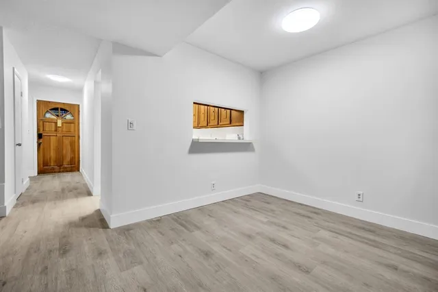 an empty room with wooden floor and closet