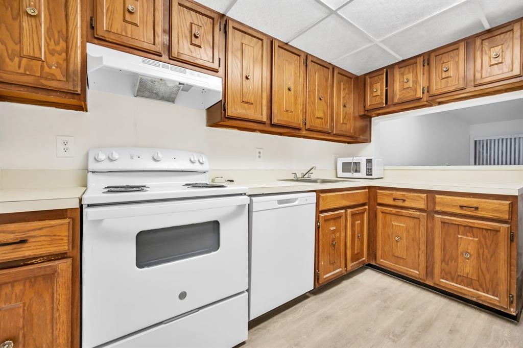 7743 Balboa Street, Unit 7743 Sunrise, FL 33351 - Photo 2 of 21 a kitchen with stainless steel appliances granite countertop a sink and dishwasher a stove with wooden cabinets