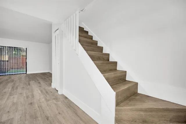 a view of entryway and hall with wooden floor