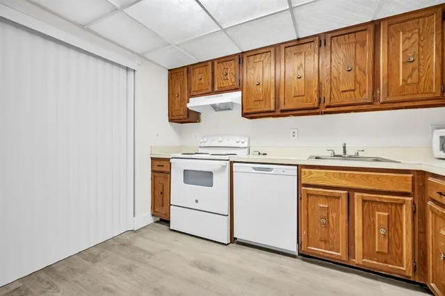 a kitchen with granite countertop cabinets stainless steel appliances and sink