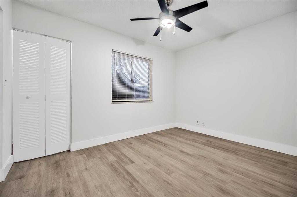 7743 Balboa Street, Unit 7743 Sunrise, FL 33351 - Photo 9 of 21 an empty room with wooden floor fan and windows