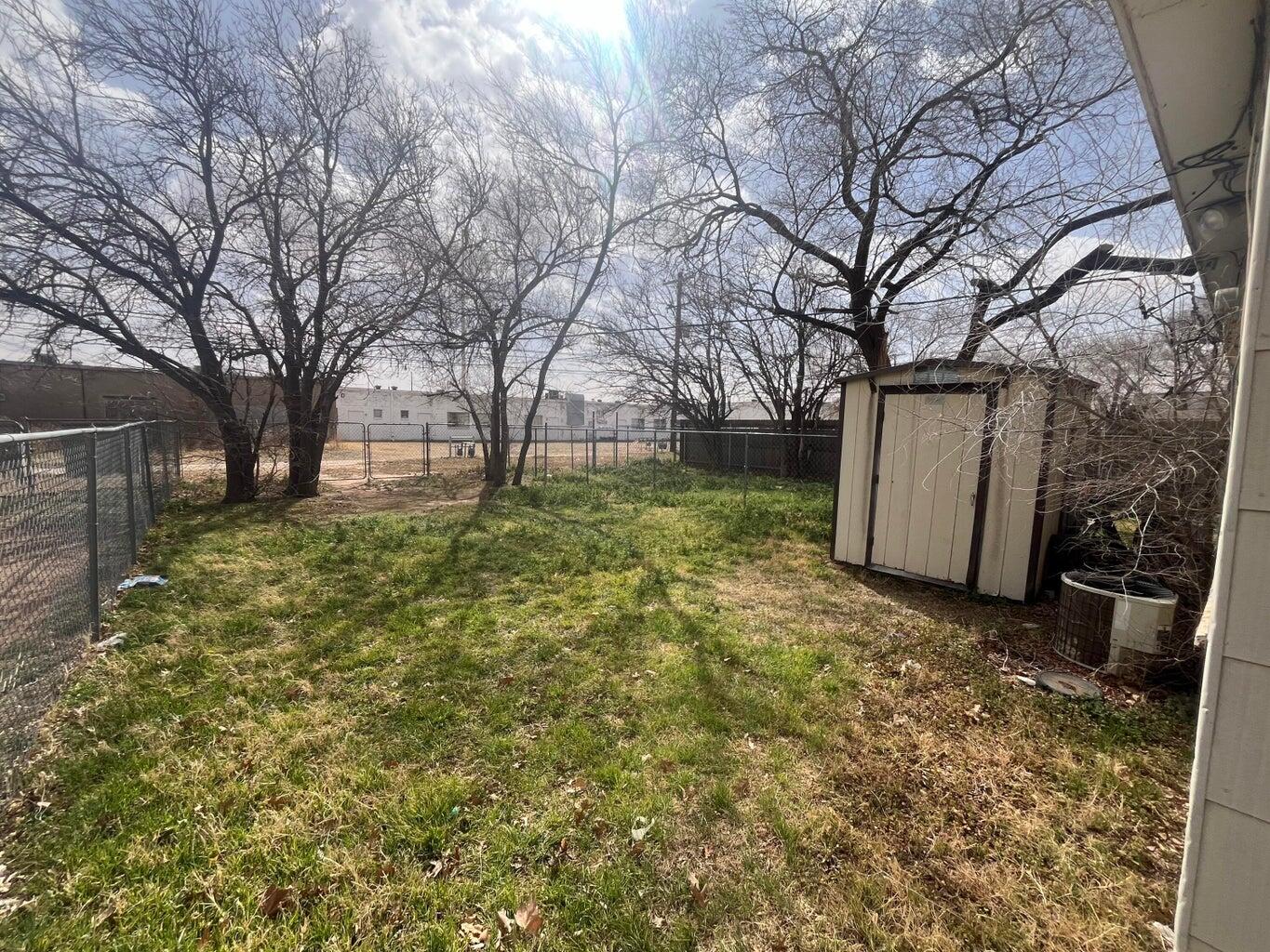 3113 33rd Street, Unit A Lubbock, TX 79410 - Photo 9 of 10 a backyard of a house with large trees