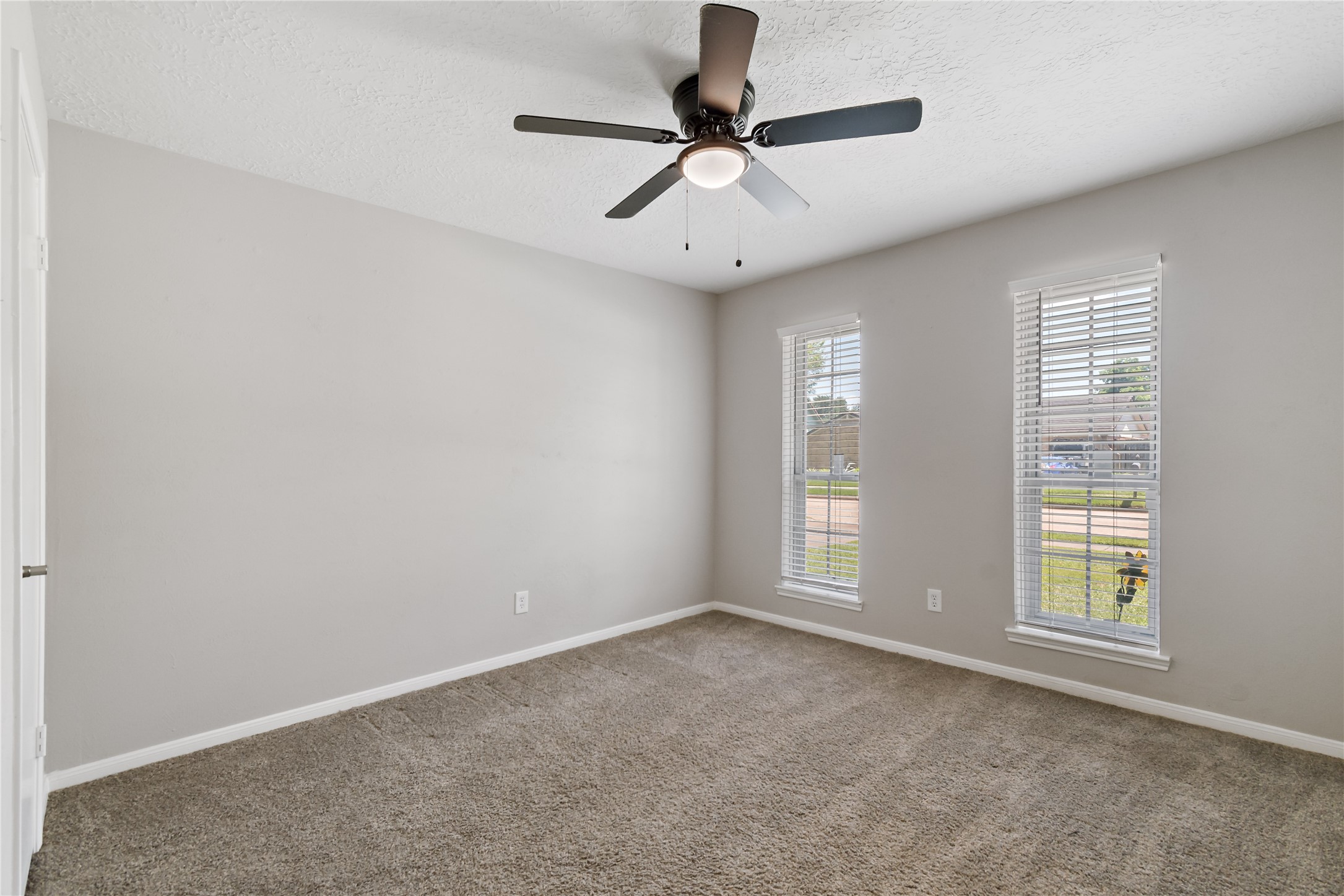 4302 Seneca Street Pasadena, TX 77504 - Photo 14 of 19 an empty room with windows and fan