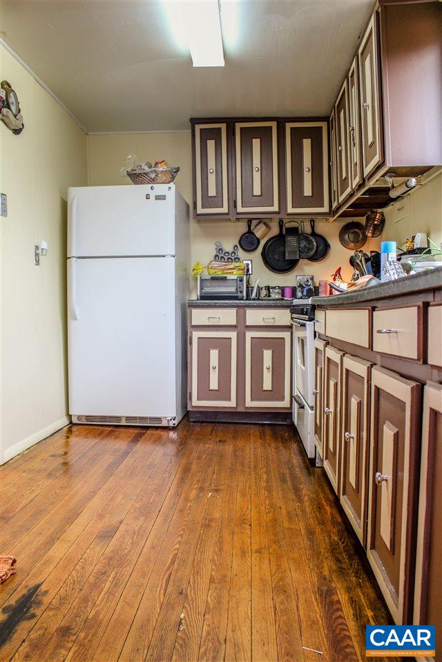 7064 Carter Road Schuyler, VA 22969 - Photo 8 of 17 a kitchen with stainless steel appliances granite countertop a refrigerator a stove and a wooden floors