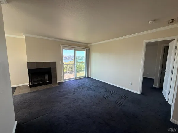 a view of empty room with a fireplace