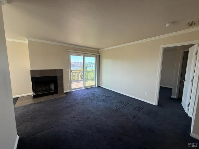 a view of empty room with a fireplace