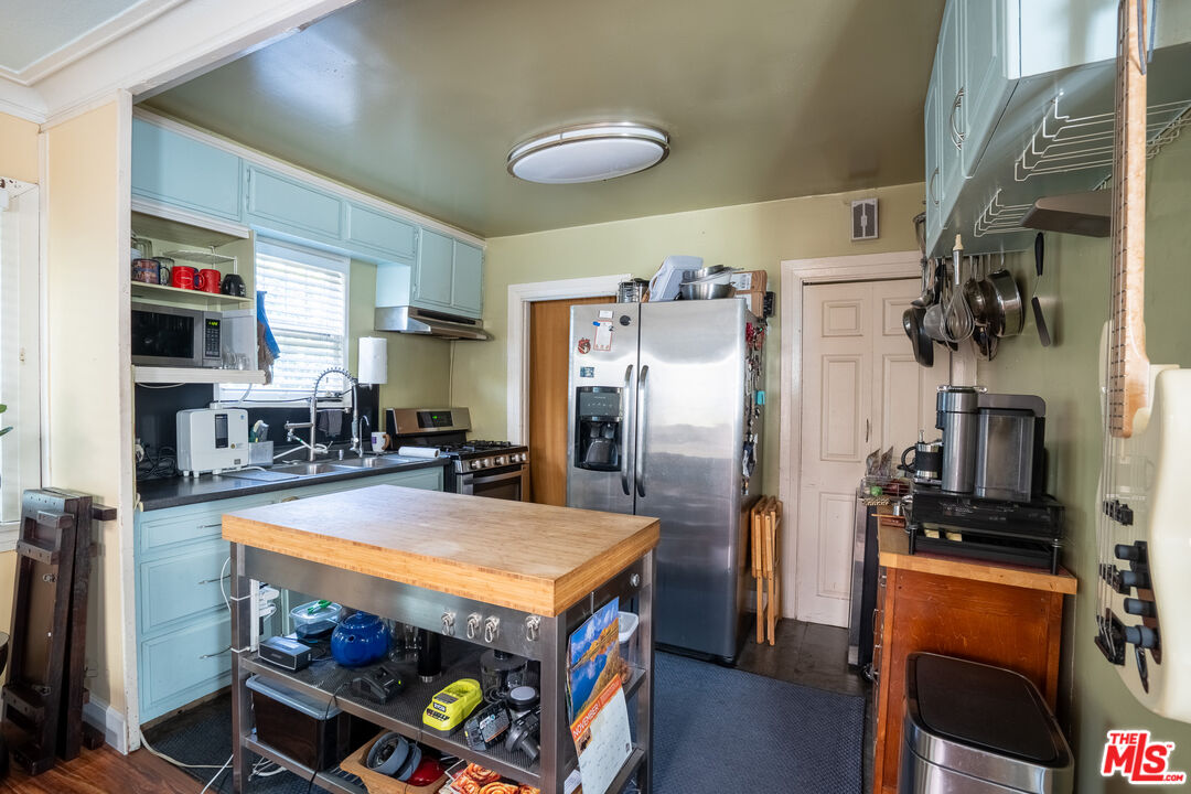 2045 Claudina Avenue Los Angeles, CA 90016 - Photo 13 of 33 a kitchen with stainless steel appliances a sink stove and refrigerator