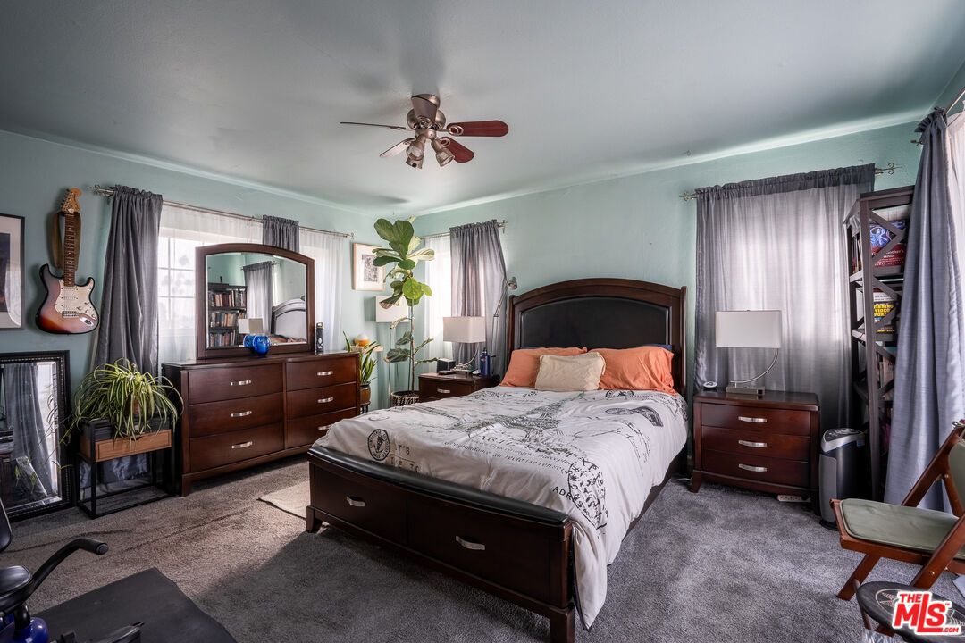2045 Claudina Avenue Los Angeles, CA 90016 - Photo 21 of 33 a spacious bedroom with a bed a dresser and potted plant