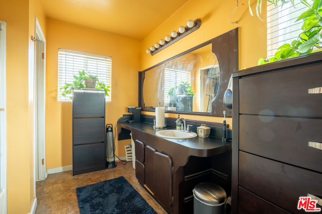 2045 Claudina Avenue Los Angeles, CA 90016 - Photo 27 of 33 a kitchen with a sink and a refrigerator