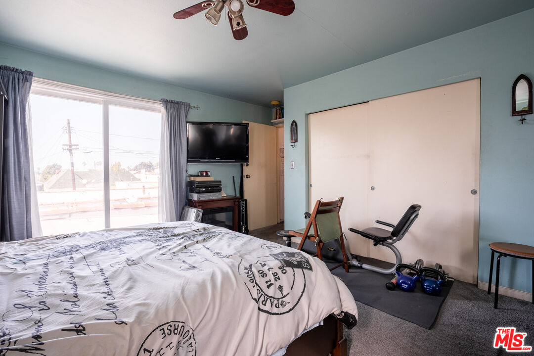 2045 Claudina Avenue Los Angeles, CA 90016 - Photo 29 of 33 a bedroom with a bed and a flat tv screen