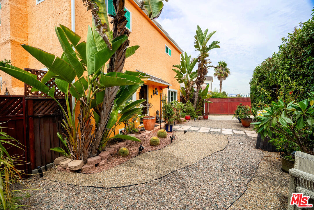 2045 Claudina Avenue Los Angeles, CA 90016 - Photo 4 of 33 a backyard of a house with table and chairs potted plants