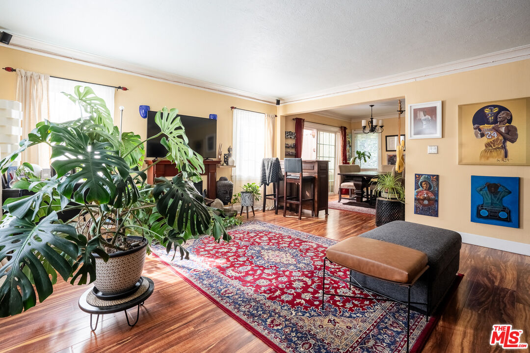 2045 Claudina Avenue Los Angeles, CA 90016 - Photo 7 of 33 a living room with furniture plant and a rug