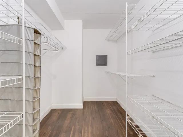 a view of walk in closet with empty racks