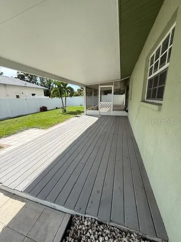 a view of a balcony with wooden floor