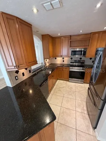 a kitchen with stainless steel appliances a sink stove and cabinets