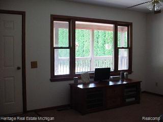 8902 West Coon Lake Road Gregory, MI 48137 - Photo 5 of 17 Living room overlooking tree-fil