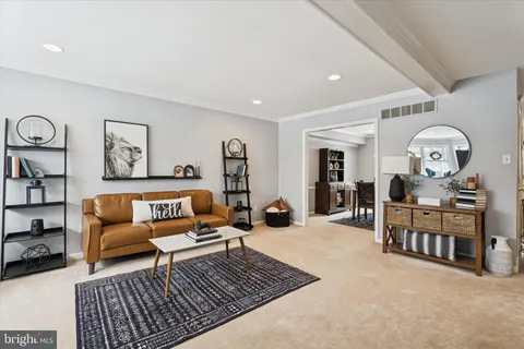 a living room with furniture a rug and a window