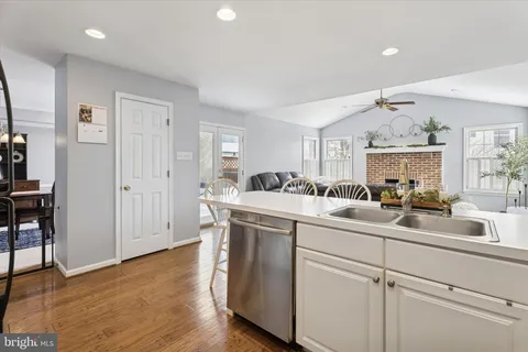 a kitchen with a sink cabinets and wooden floor