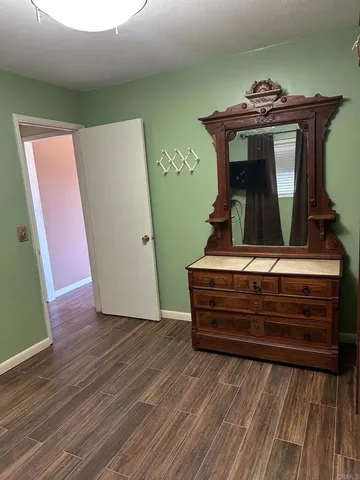 a view of a room with wooden floor and stairs