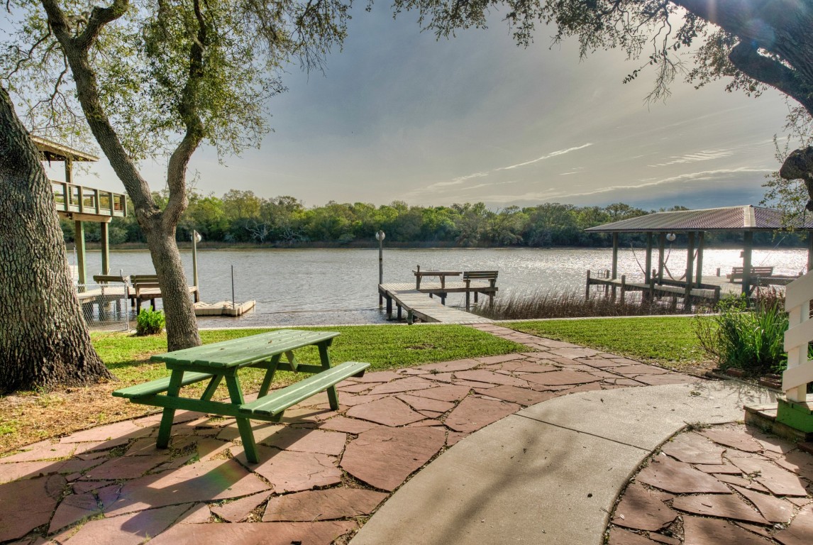 4641 Rio Drive Brazoria, TX 77422 - Photo 4 of 33 a view of a lake with a bench and trees around
