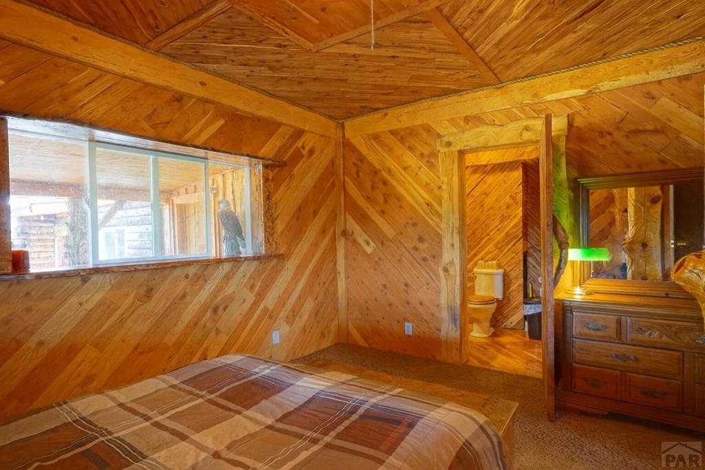 31300 Timber Canyon Road Trinidad, CO 81082 - Photo 22 of 59 a bedroom with a bed and wooden floor