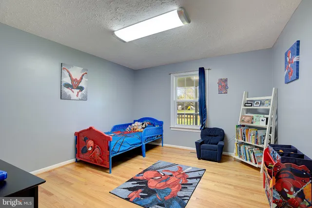 a bedroom with furniture toys and a window