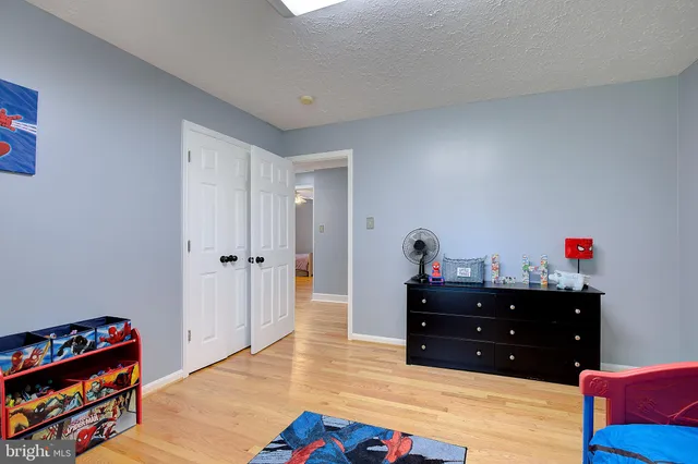a bed room with a bed and a book shelf