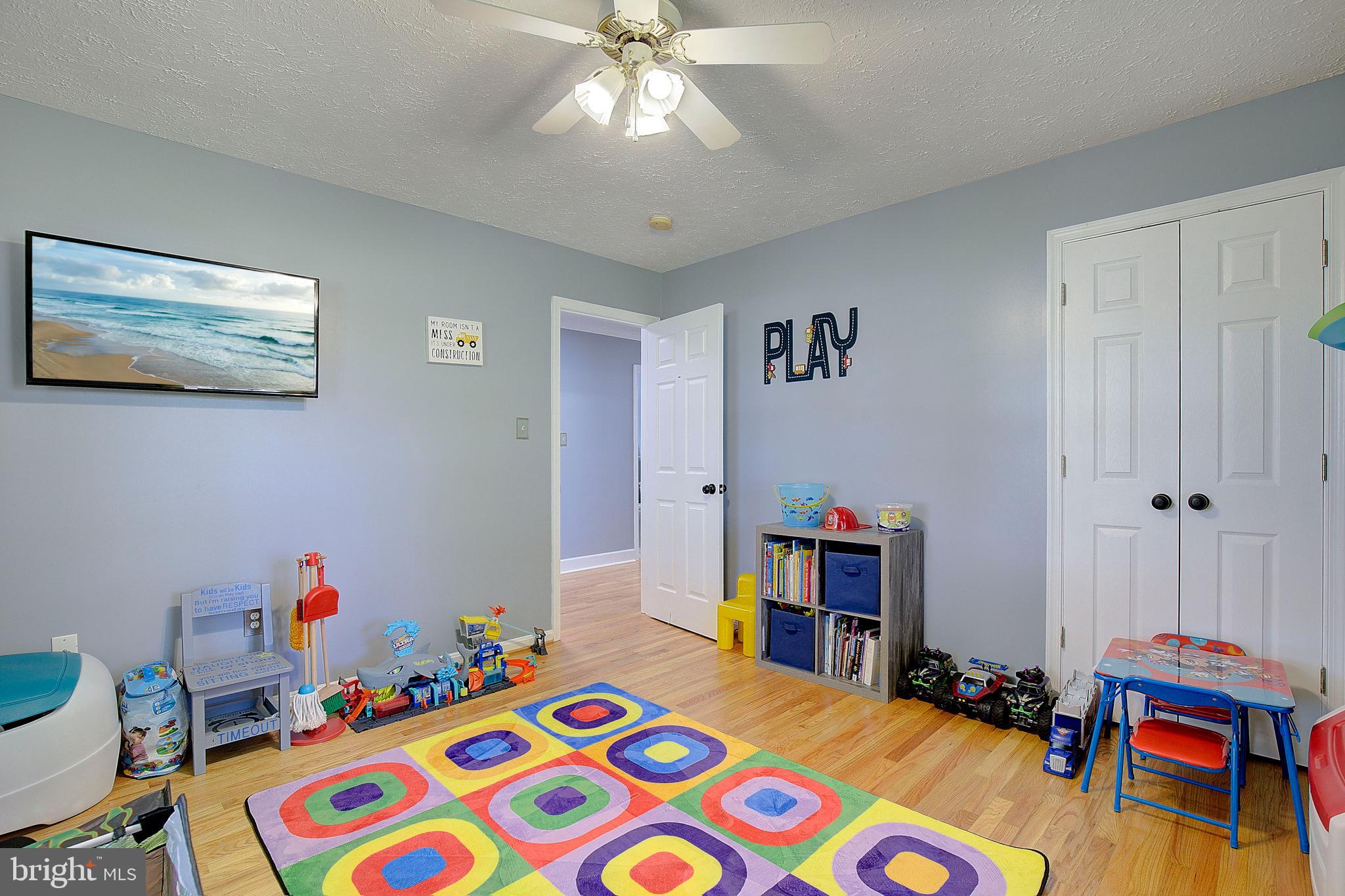 26282 Rio Bravo Lane Mechanicsville, MD 20659 - Photo 24 of 52 a bedroom with a bed and a wooden floor