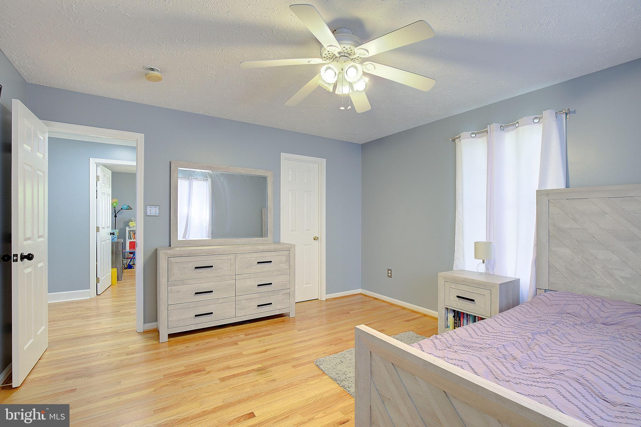 26282 Rio Bravo Lane Mechanicsville, MD 20659 - Photo 27 of 52 a bedroom with a bed and a chandelier