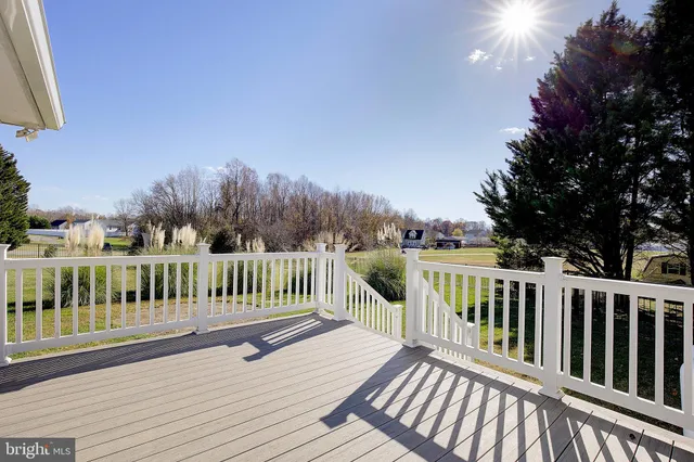 a view of balcony with wooden floor and fence