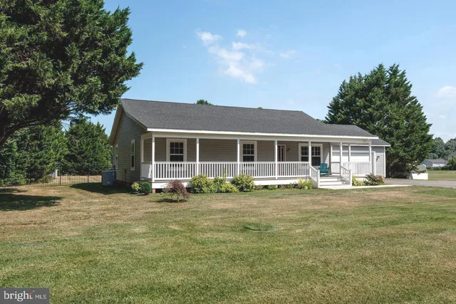 a view of a porch with wooden floor and fence