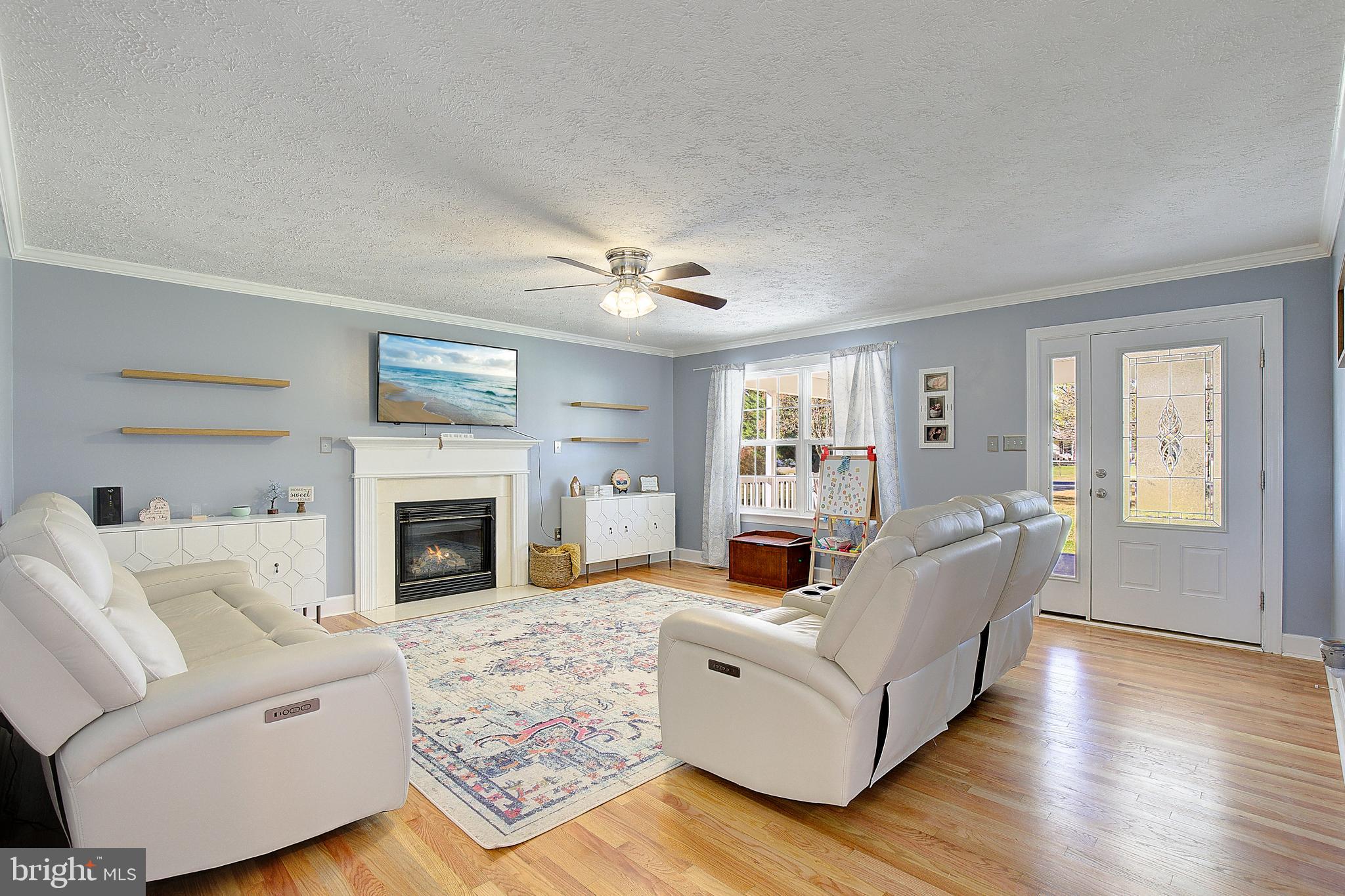 26282 Rio Bravo Lane Mechanicsville, MD 20659 - Photo 7 of 52 a living room with furniture and a fireplace