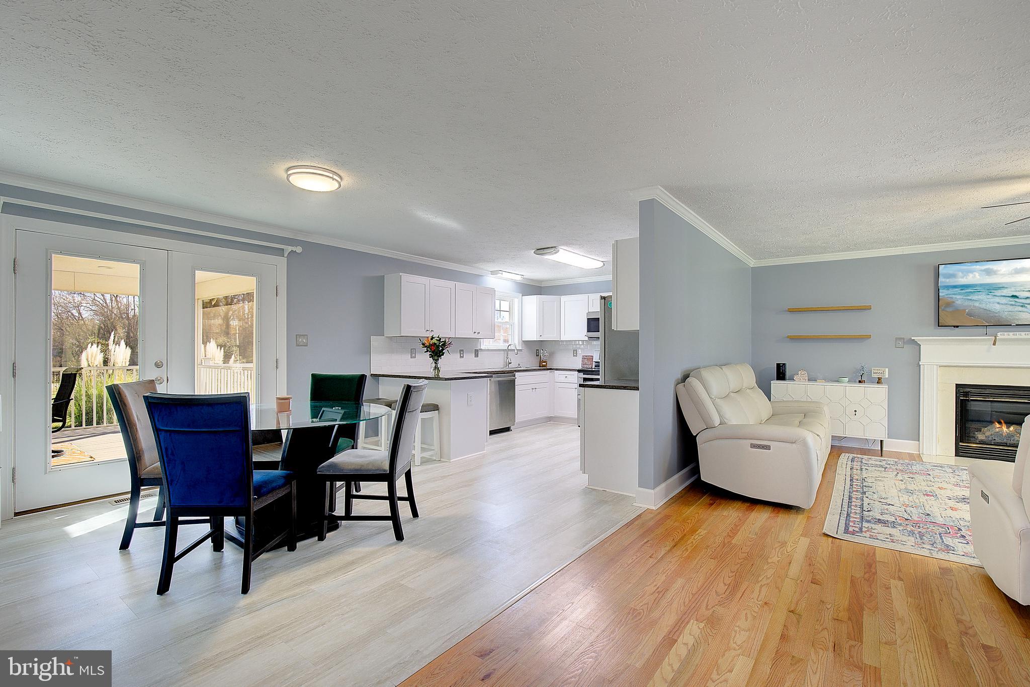 26282 Rio Bravo Lane Mechanicsville, MD 20659 - Photo 9 of 52 a living room with furniture and a dining table with wooden floor