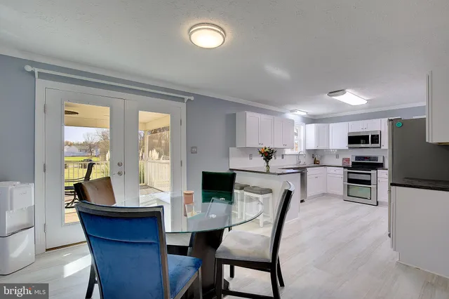 a living room with furniture a fireplace and a kitchen view